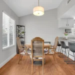 dining area with wooden floors, a round table with four chairs.