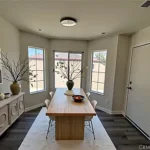 dining room with a wooden table, and white chairs in California