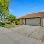 Real estate house with a red-tiled roof and a double garage