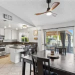 Dining area with wood table and chairs, with stainless steel appliance