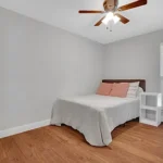 bedroom in California with a white bedding and wooden floor