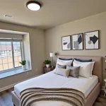 bedroom with a bed and abstract art on the wall.