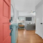 Living room with wooden floors, gray sofas and ceiling fan